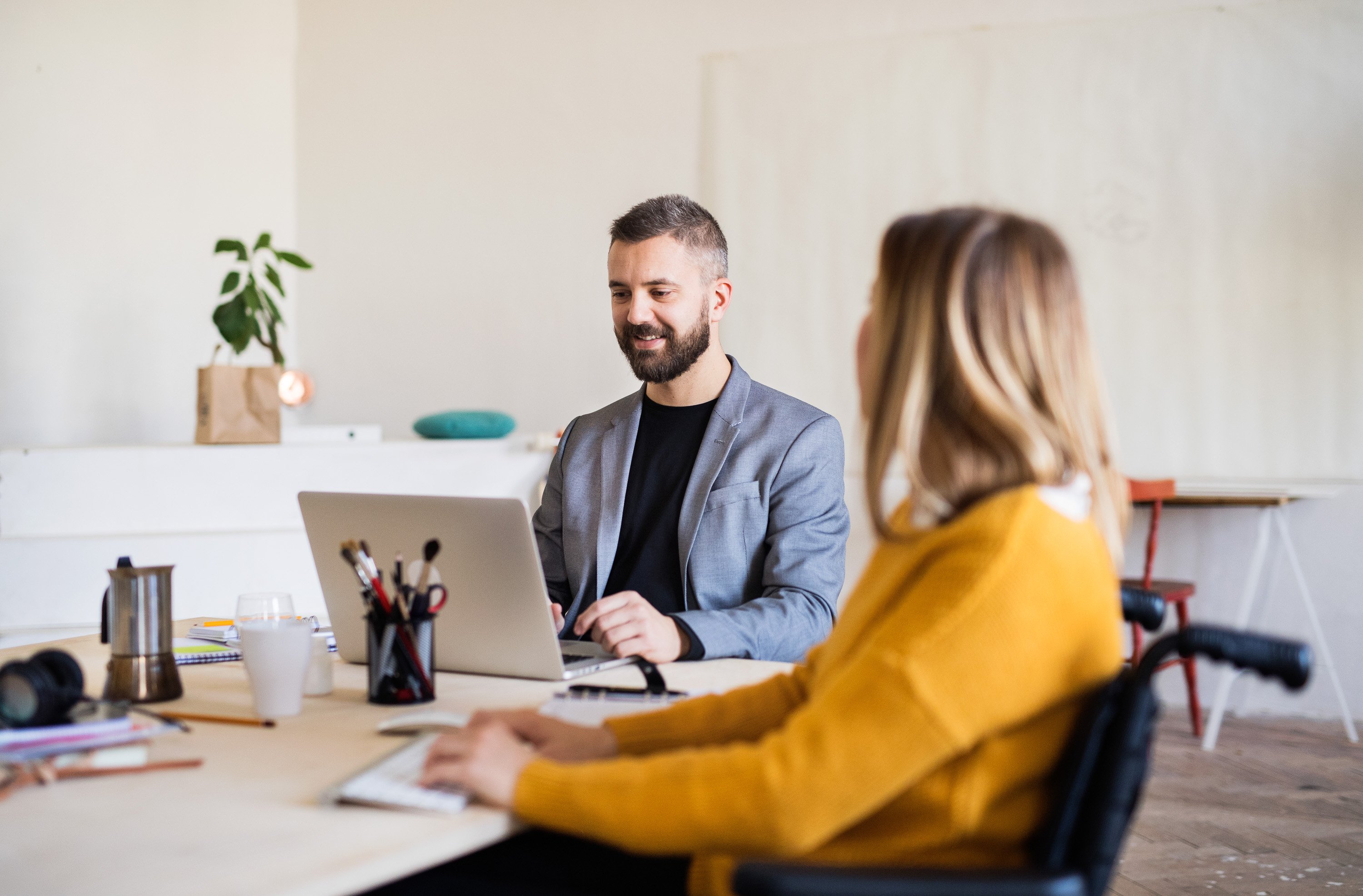 two-business-people-with-wheelchair-in-the-office-2026-01-05-06-15-04-utc